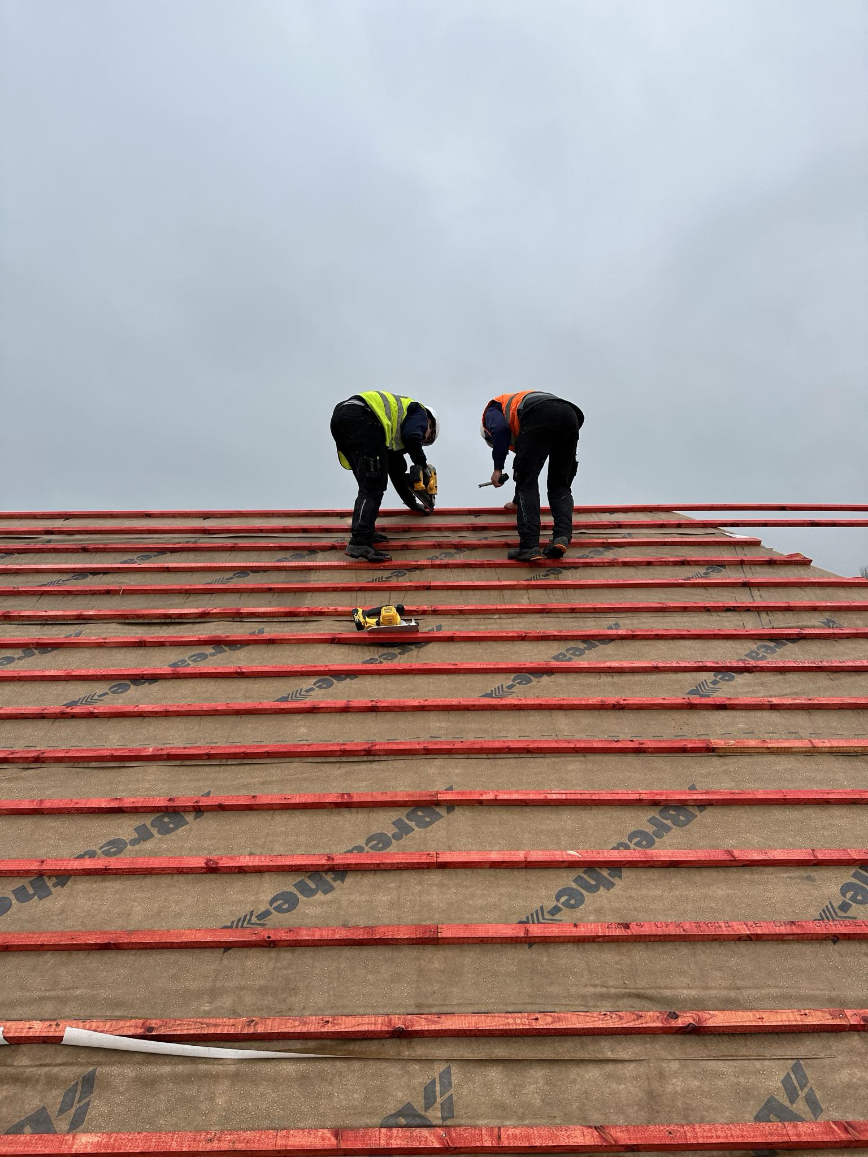 Perfect Roofing installing breathable membrane and battens on a pitched roof