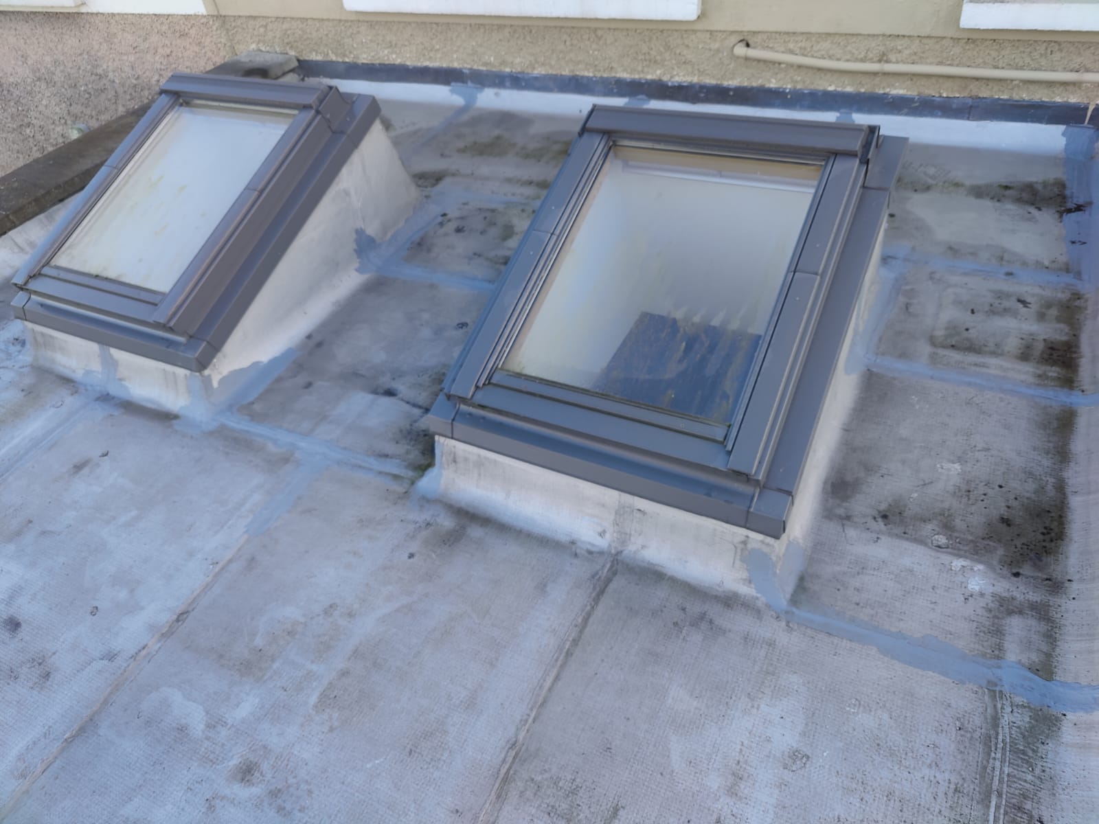 Two Velux roof windows installed into a flat roof by Perfect Roofing